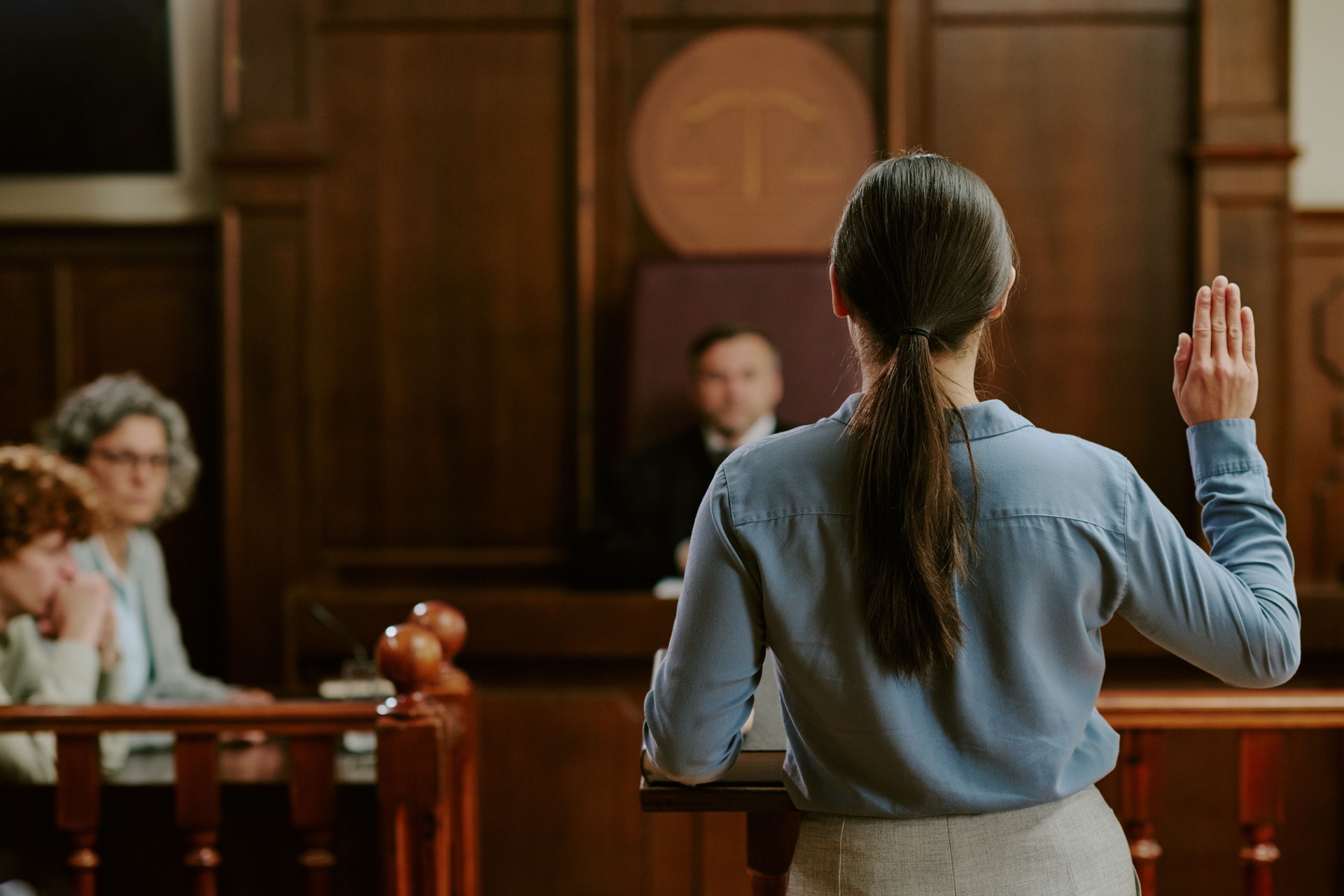 Young Caucasian Woman Testifying in Courtroom during Legal Proceedings